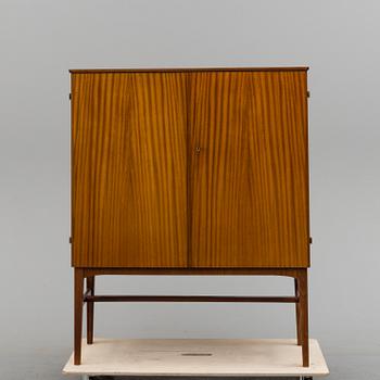 A 1950s mahogany veneered cabinet.