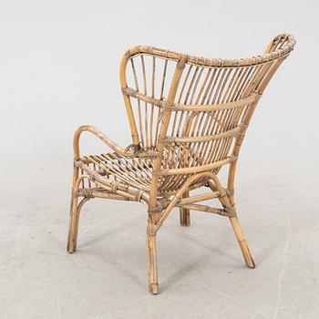 A mid 1900s bamboo and rattan armchair.