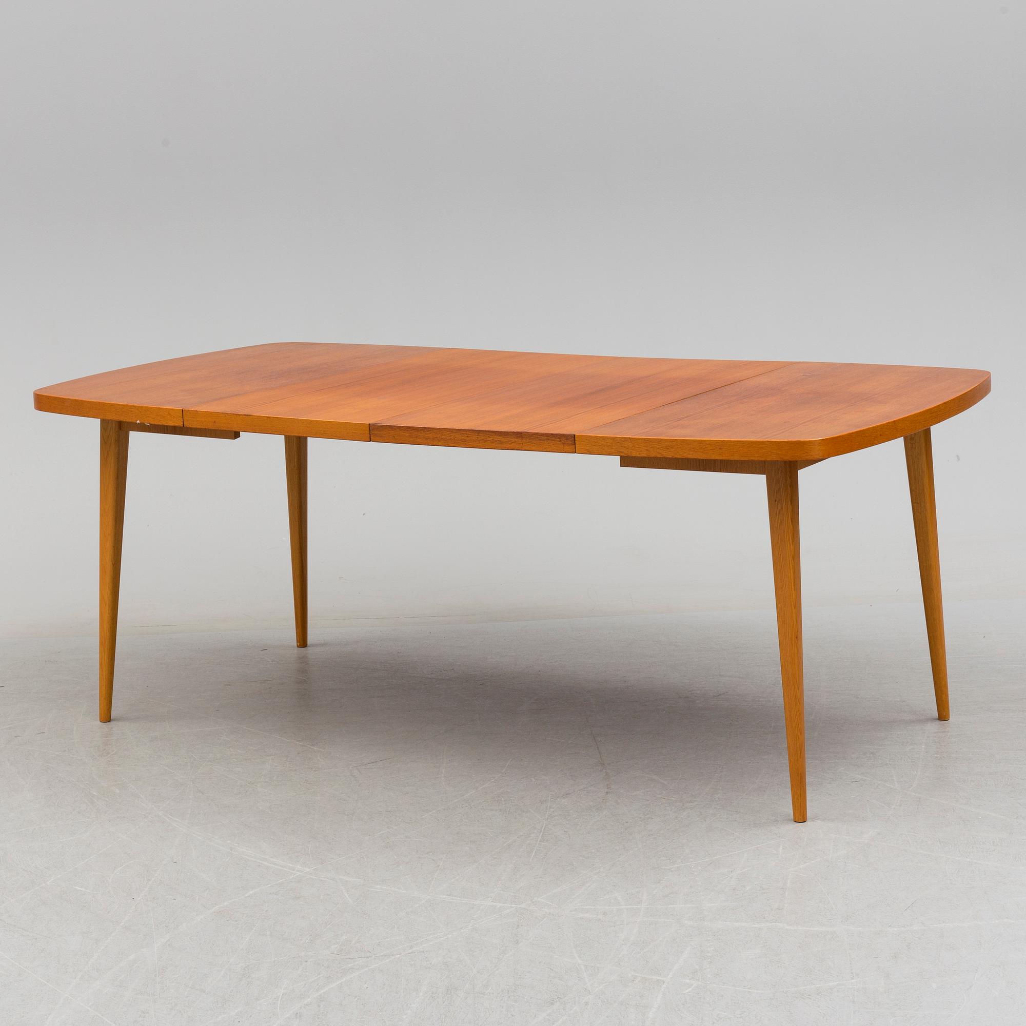 A 1950s teak and teak veneer table.