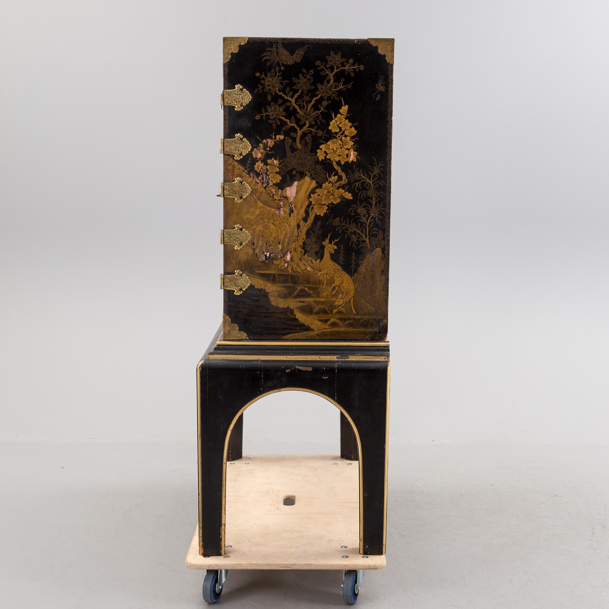 AN early 18TH CENTURY PROBABLY ENGLISH Japanned laquer cabinet on stand.