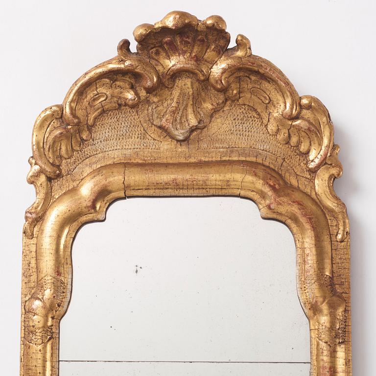 A matched pair of rococo giltwood one-light girandoles, later part of the 18th century.