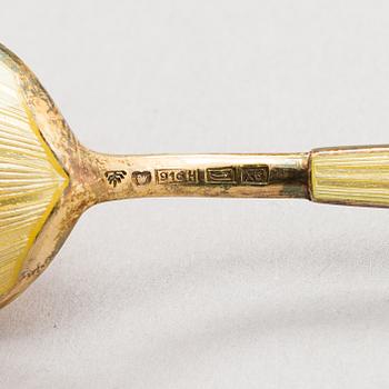 Tillander, a set of twelve enamelled gilt silver spoons, Helsinki 1951.