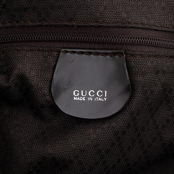 Gucci, a chocolate brown nylon handbag.