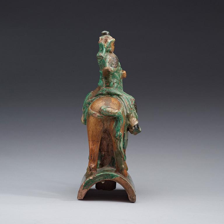 A green and brown glazed ridge tile figure of Guan Yu riding a horse, Ming dynasty  17th century.