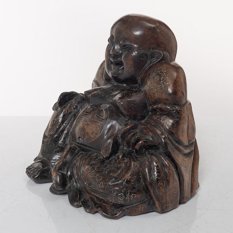 A Chinese wooden figure of Budai with silver inlays, Qing dynasty (1644-1912).