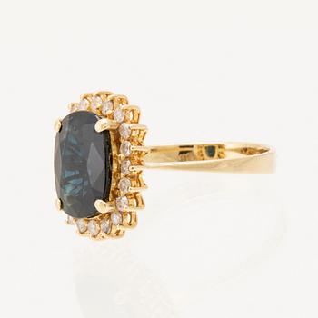 Ring in 14K gold with faceted sapphire and round brilliant-cut diamonds.