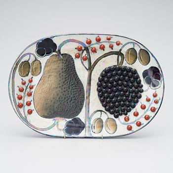 BIRGER KAIPIAINEN, A CERAMIC DISH. A pear and berries. Signed Kaipiainen Arabia. 1970s.