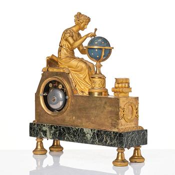 A patinated, ormolu, and marble French Empire figural mantel clock, early 19th century.