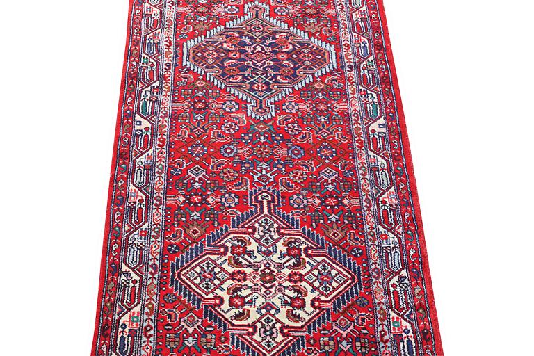 A Hosseinabad runner carpet, c. 304 x 84 cm.