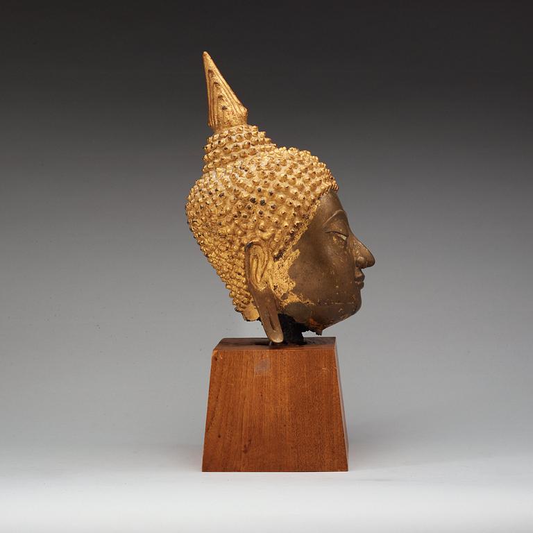 A gilt bronze head of Buddha, Thailand, 19th Century.