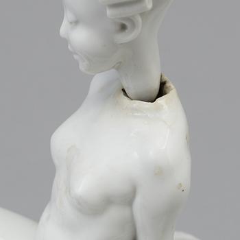 A white glazed Royal Copenhagen porcelain nodding head figure, Denmark, early 20th Century. Not first quality.