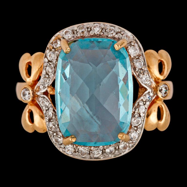 An aquamarine and white sapphire ring.