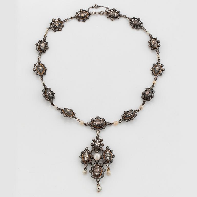 A silver necklace/pendant set with rose-cut diamonds and pearls.