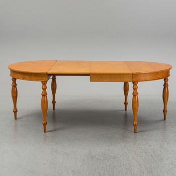 A mid 19th century birch dining table.
