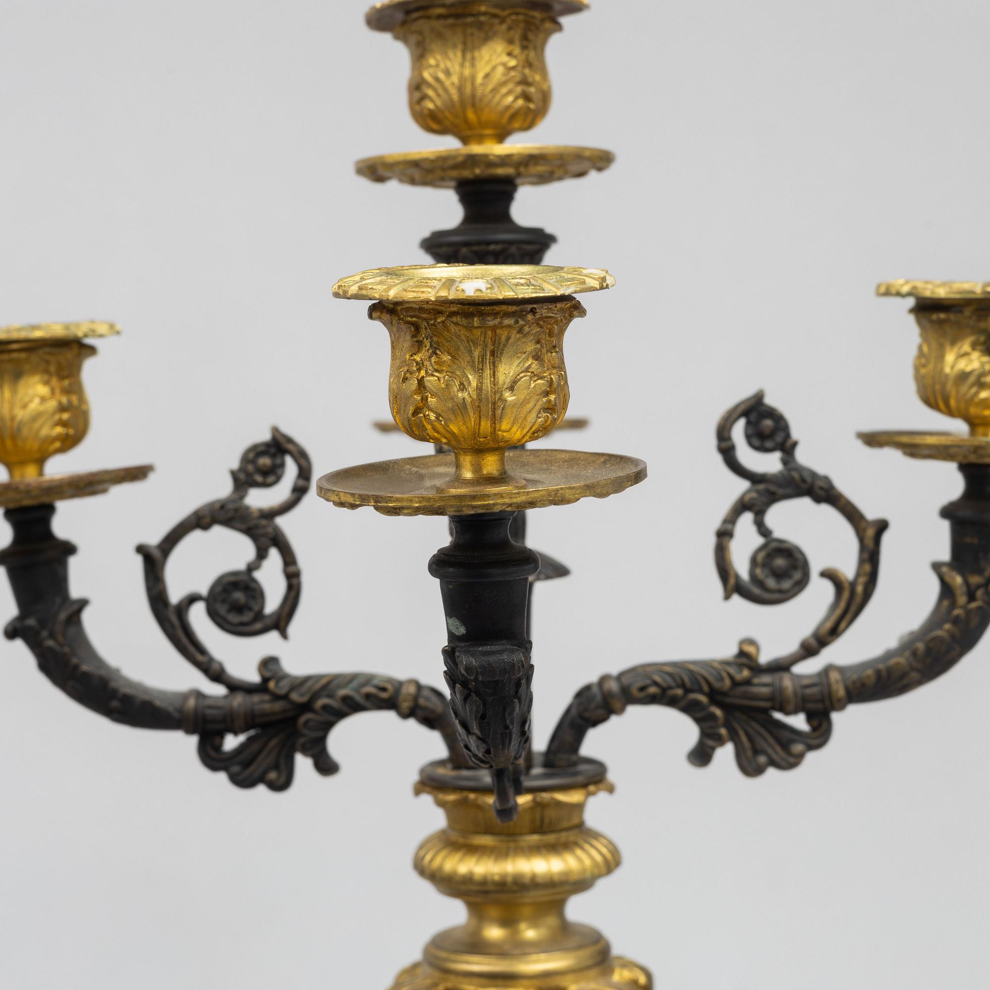 A pair of French Empire-style patinated and gilt bronze five-light candelabra, later part 19th century.