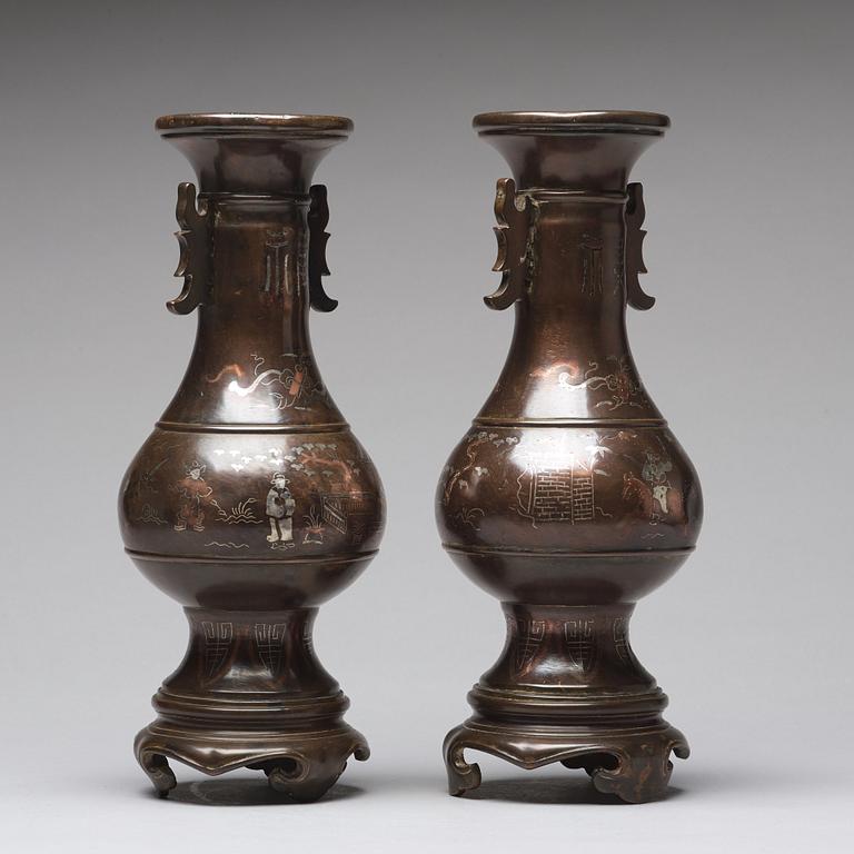 A pair of bronze vases with copper and silver inlay, Qing dynasty (1664-1912).