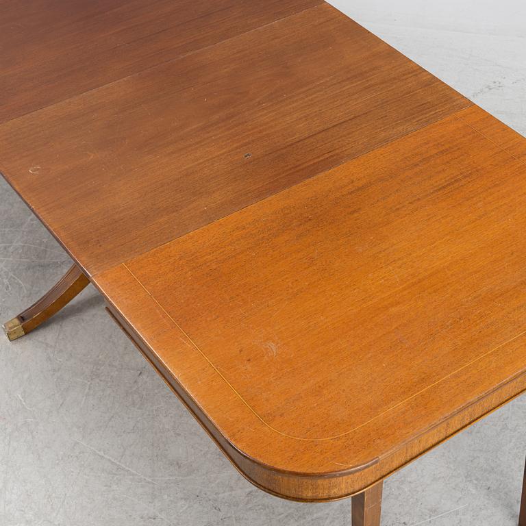 An mahogany veneered english style dining table, mid 20th century.