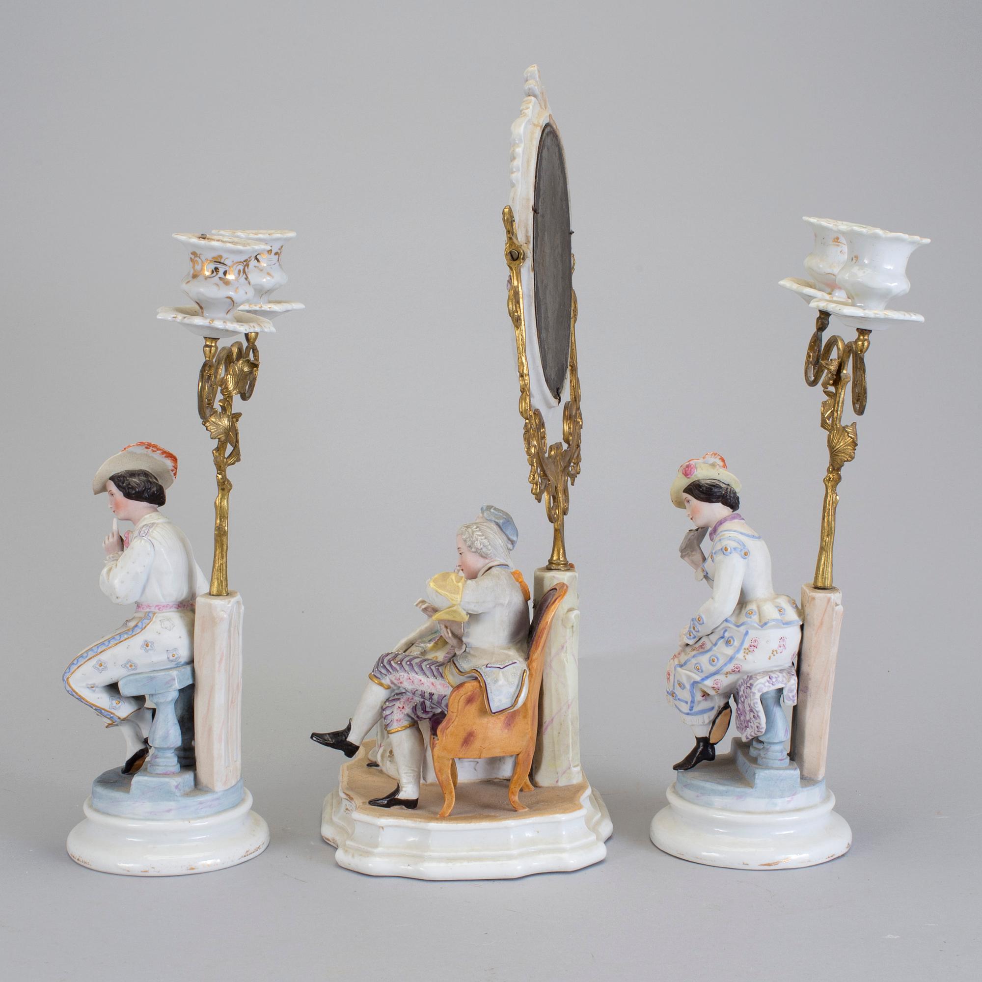 A late 18th century porcelain and biscuit toilette mirror and pair of candelabrar.