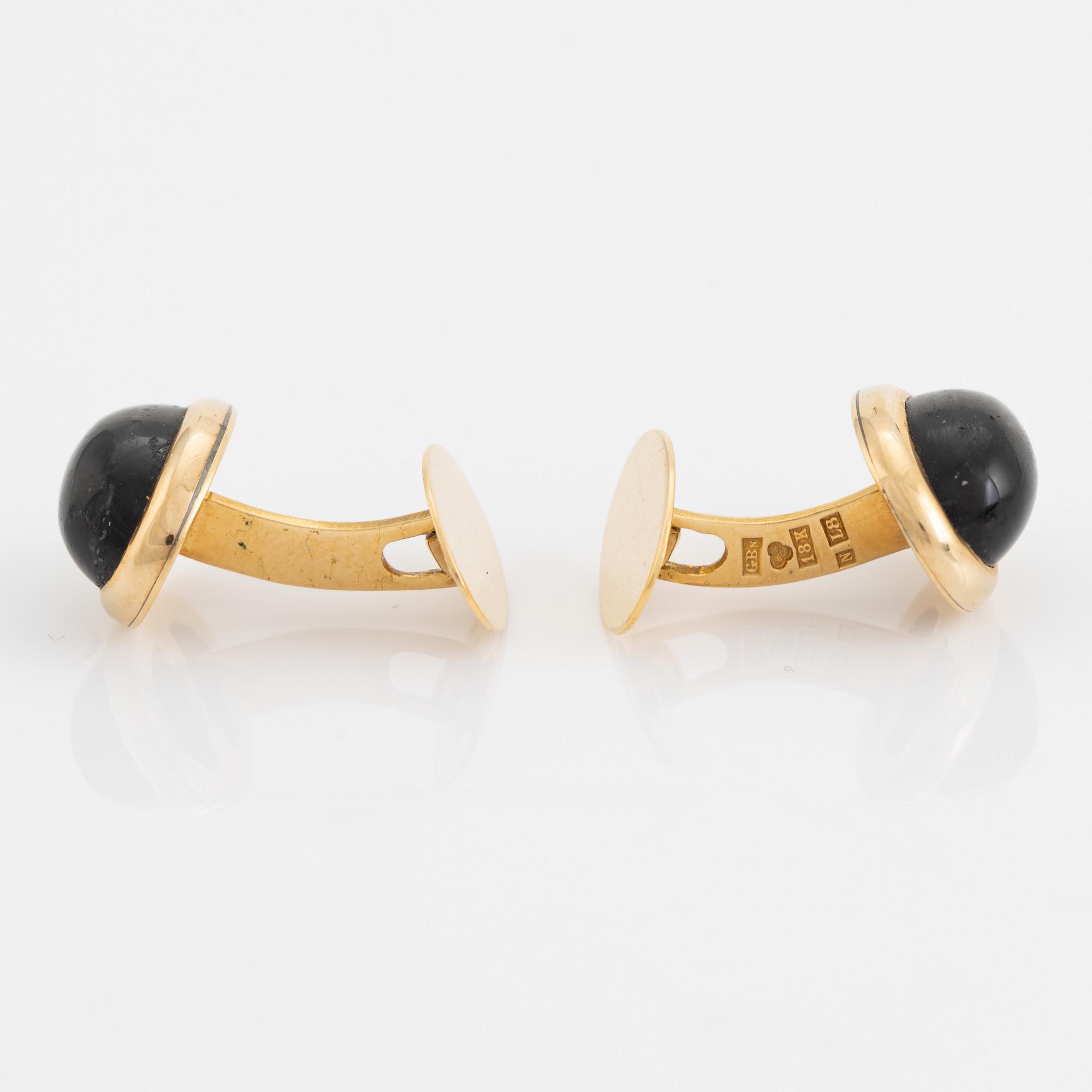 18K gold and cabochon cut blue stone cufflinks.