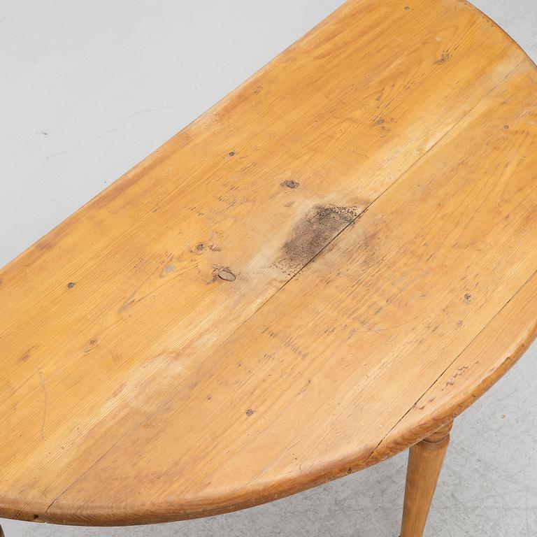 A round pine dining table/a pair of crescent shaped tables, Sweden, 19th century.