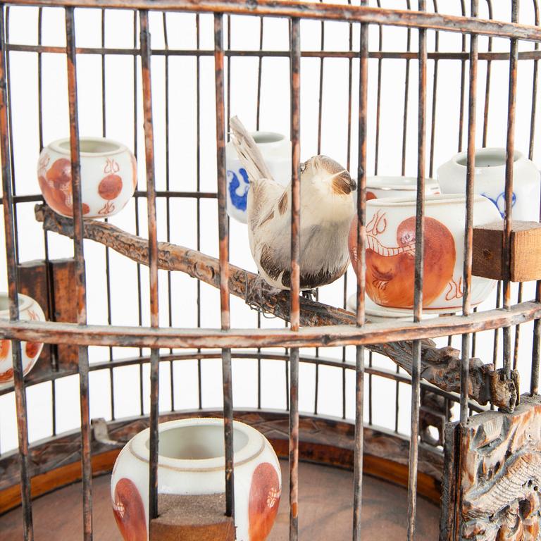 A Chinese bird cage with bird feeders, 20th Century.