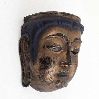 A lacquered wooden mask, 20th century.