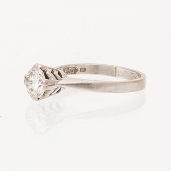 An 18K white gold solitaire ring set with a round brilliant cut diamond.