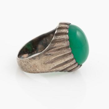 Silver ring with a green cabochon-cut stone.