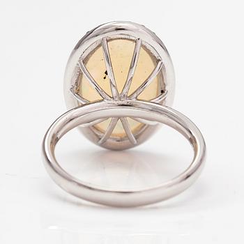 An 18K white gold ring with an opal ca. 4.64 ct and diamonds ca. 0.35 ct in total according to certificate.