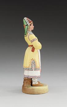 A unmarked Russian bisquit figure depicting a Mordvinian woman, ca 1900.