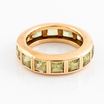 An 18K gold ring set with step-cut peridots.