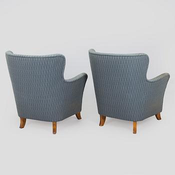 A pair of mid-20th century armchairs.