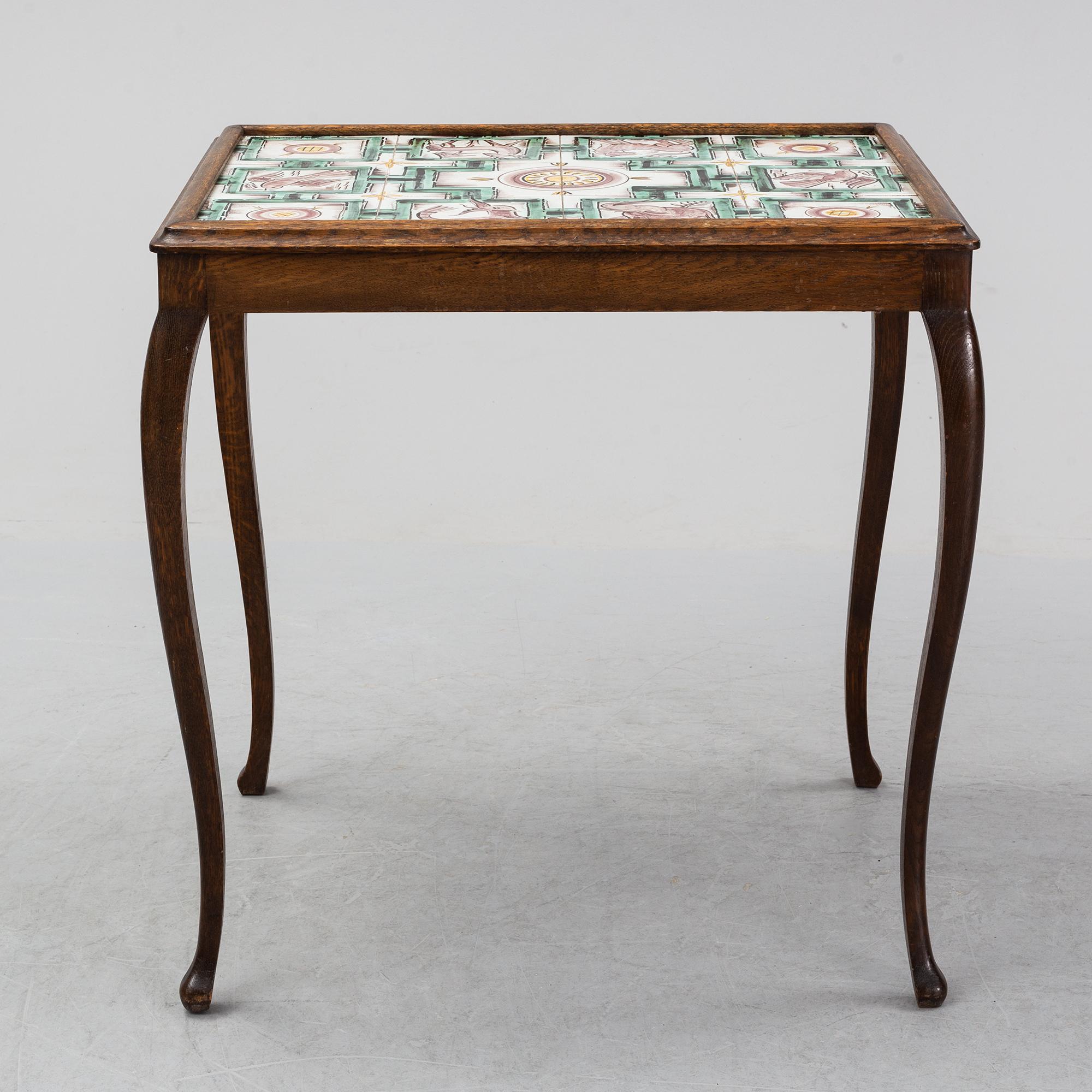 An oak table with glazed tiles by  Anna-Lisa Thomson, S.t Erik, dated 1931.