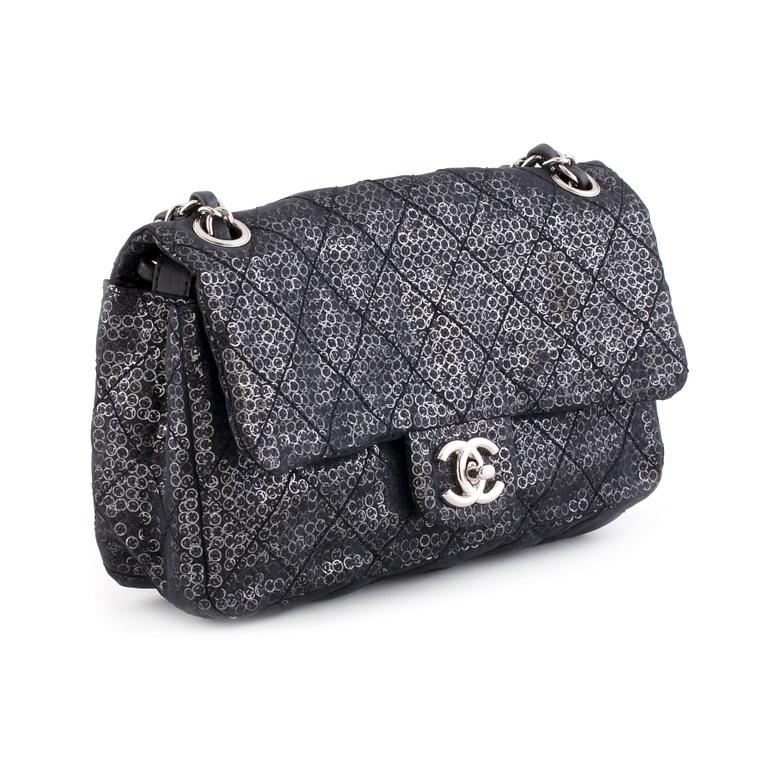 CHANEL, a black and silver tinsel evening "Flap-bag".