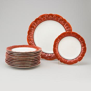 Twelve plates and a charger, stoneware, Gefle, first half of the 2th century.