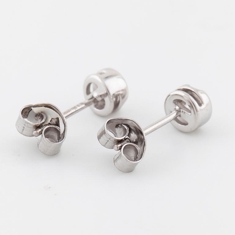 A pair of brilliant cut diamond earrings.