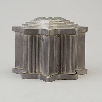 a pewter ice cream mold from the 19th century.