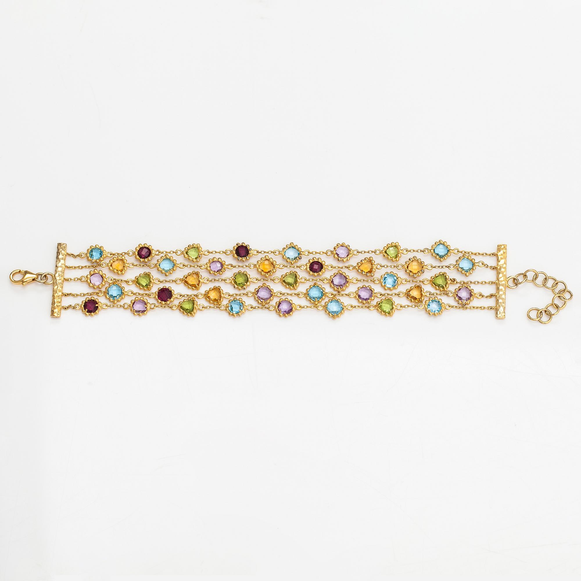 A gilded silver bracelet with topazes, garnets, peridotes, amethysts and quartzes.