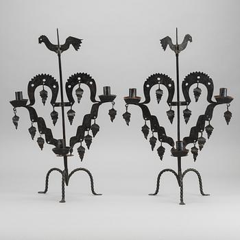 KANDELABRAR , 2 st  smide, "Tuppljusstake" Design Gustaf Ancarkrona, Käck & Hedbys, Leksand.