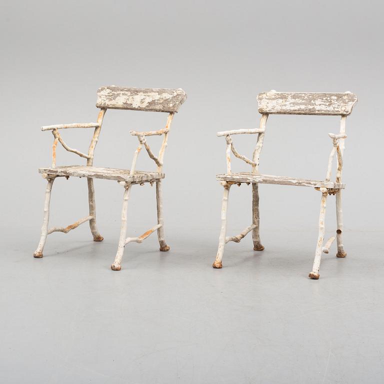 a pair of early 20th century garden cast iron chairs.