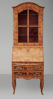 145. A Rococo walnut writing cupboard.
