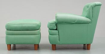A Josef Frank armchair with ottoman, by Svenskt Tenn, model 568.