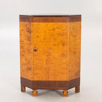 A 1930s birch corner cabinet.