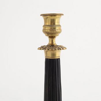 A pair of brass candle sticks, late empire, mid 19th century.