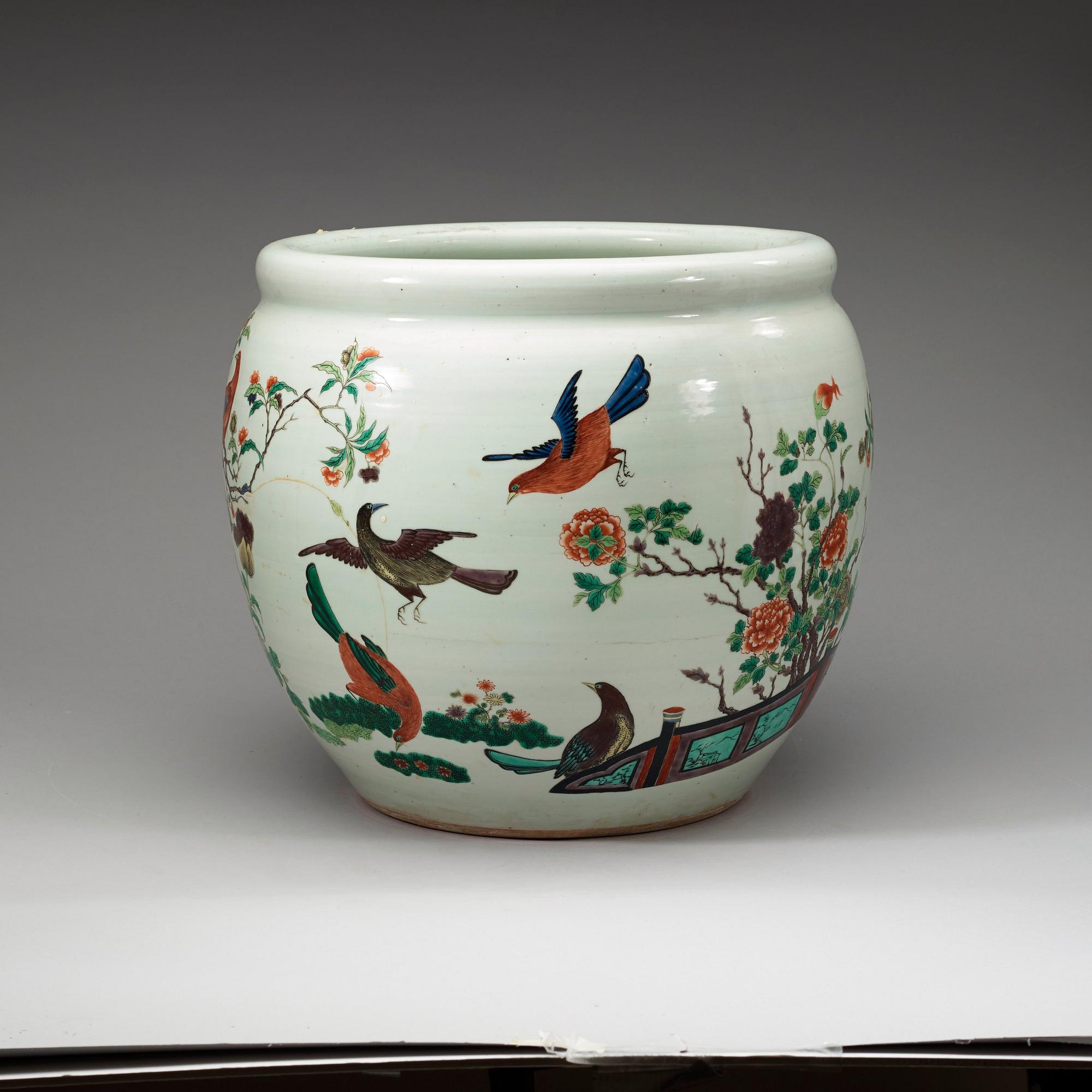 A famille rose jardiniere, decorated with a terrace scene with blossom and birds, late Qing dynasty, about 1900.