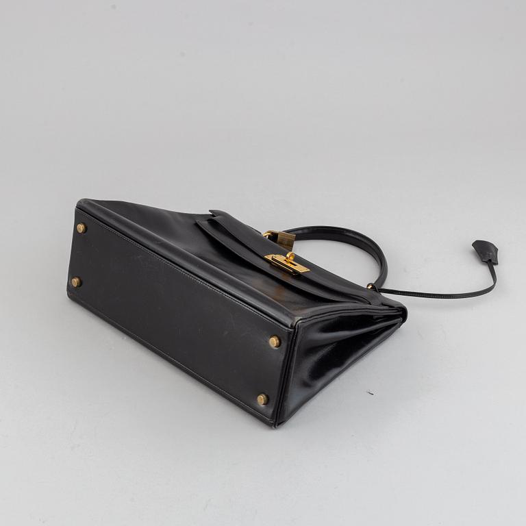 Hermès,a black leather 'Kelly 32' handbag, 1975.
