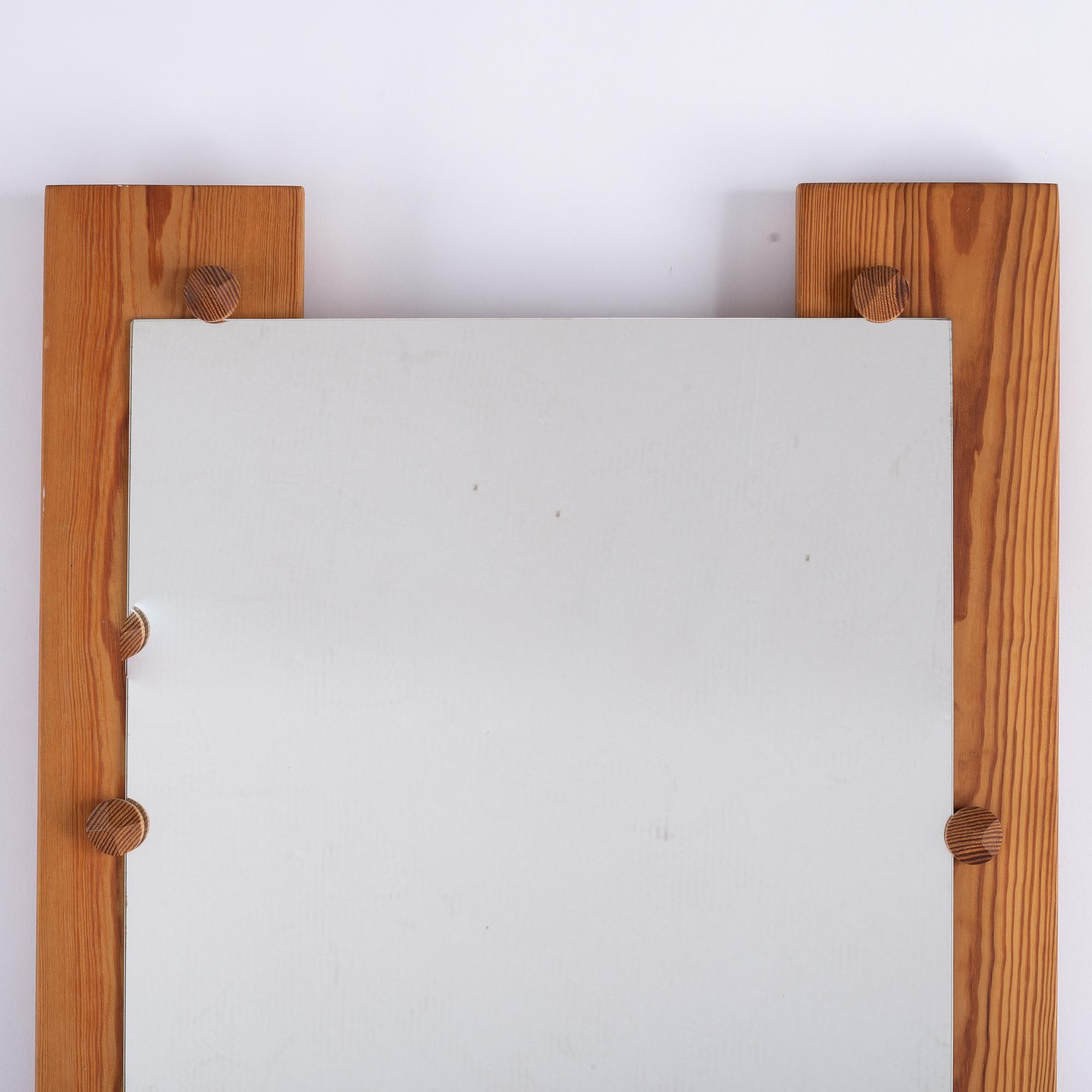 A pine mirror by Gunar Kanevad, signed and dated 1971.