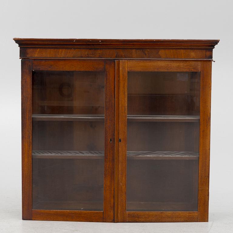 A mahogany veneered vitrine wal cabinet.