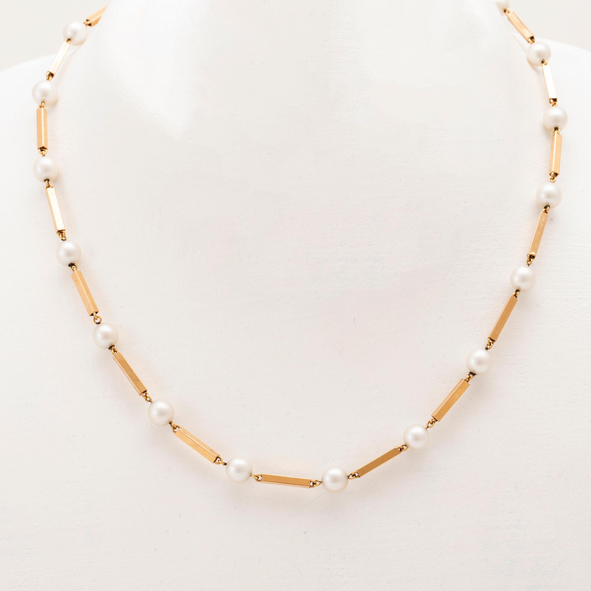 A set of 18K gold necklace and earrings with cultured pearls.