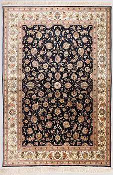 An oriental silk carpet. Circa 185x125 cm.